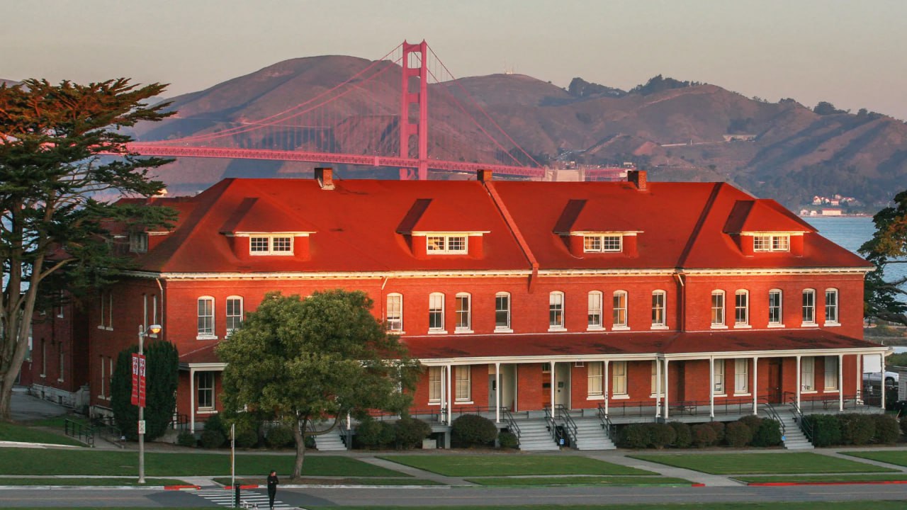 The House, a red-brick building in the Presidio with the Golden Gate Bridge behind it